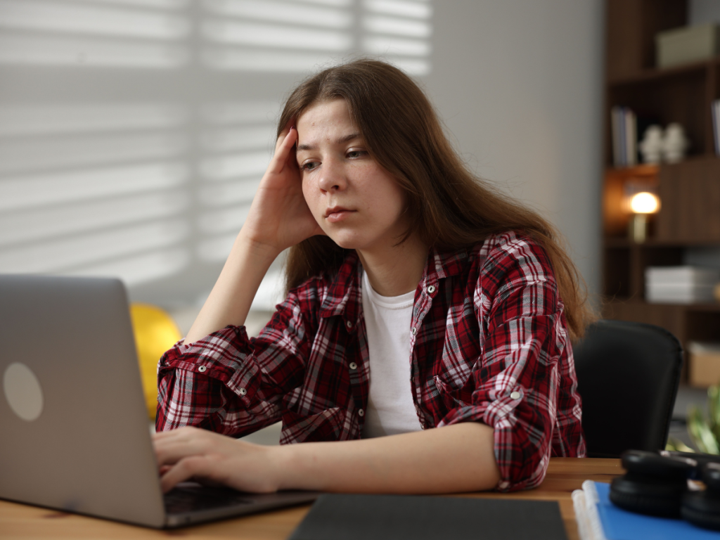 Year 10 teenage girl studying at desk indoors